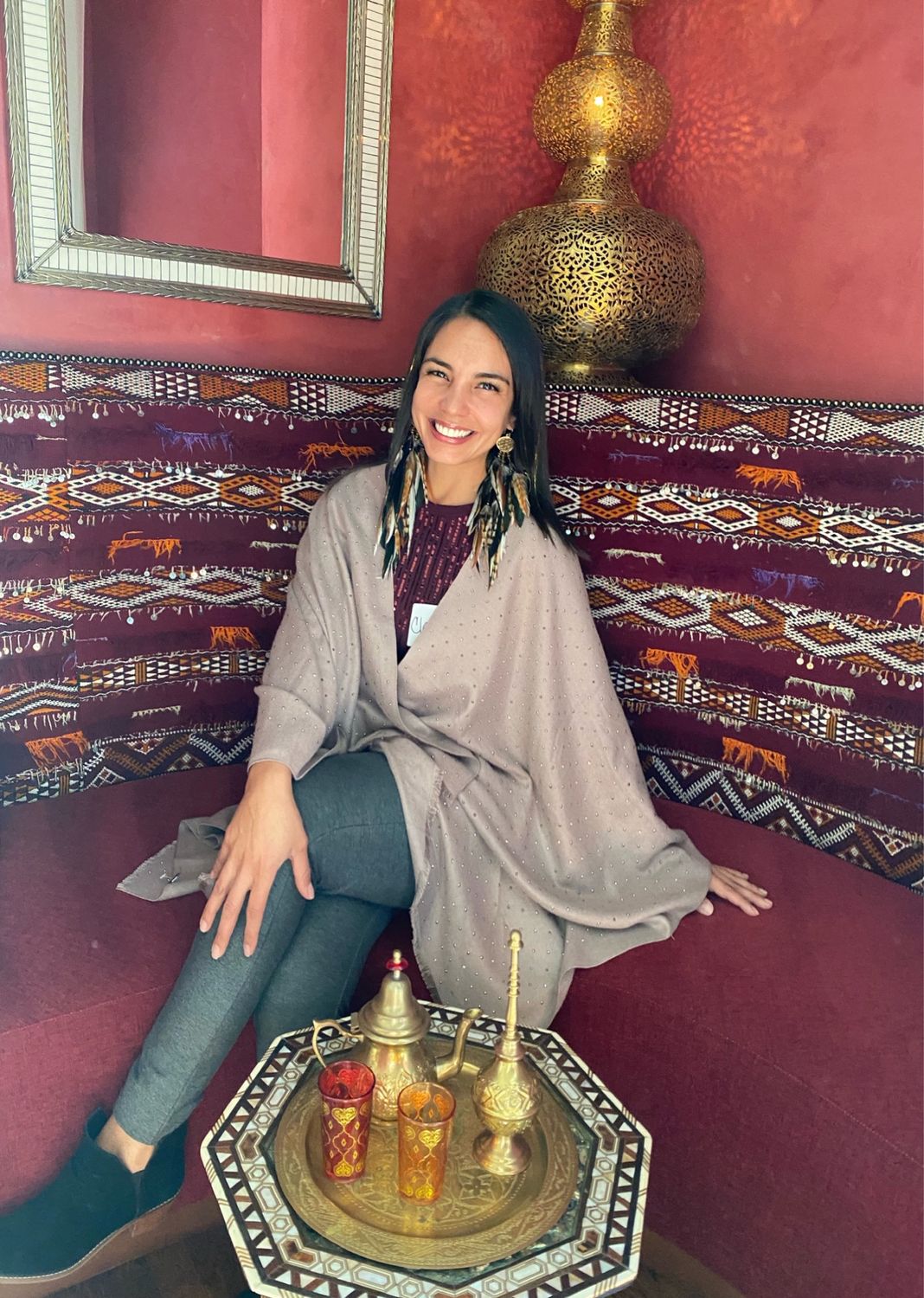 Claudia Salerno seated in a warm interior setting